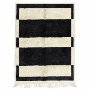 Handwoven wool rug with bold black and cream horizontal stripes and fringe, modern Moroccan design.