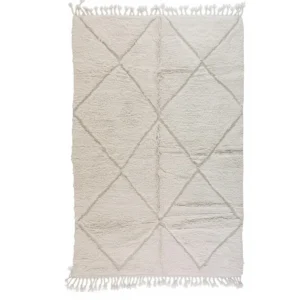 Handwoven Beni Ourain wool rug with classic diamond pattern and fringe, crafted in Morocco