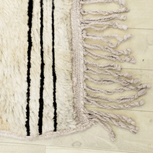 Handmade Beni Ourain rug with classic black and white horizontal stripes, showcasing traditional Moroccan craftsmanship. Perfect for adding a touch of minimalistic elegance and warmth to any living space