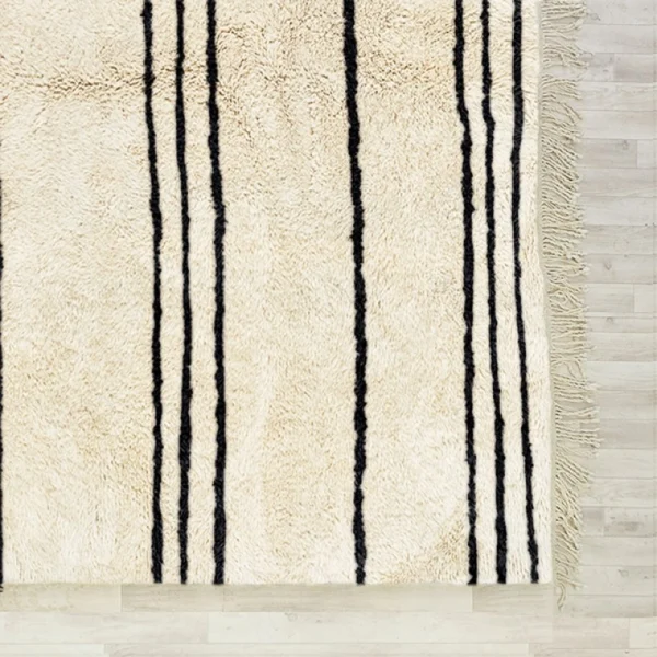 Handmade Beni Ourain rug with classic black and white horizontal stripes, showcasing traditional Moroccan craftsmanship. Perfect for adding a touch of minimalistic elegance and warmth to any living space