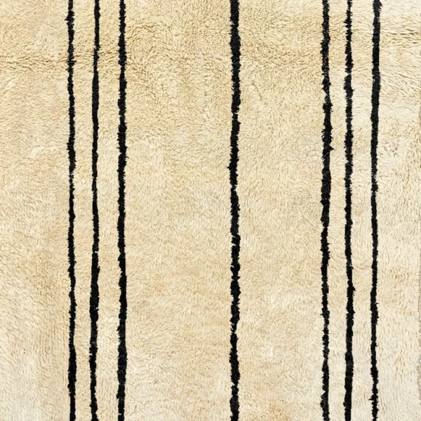 Handmade Beni Ourain rug with classic black and white horizontal stripes, showcasing traditional Moroccan craftsmanship. Perfect for adding a touch of minimalistic elegance and warmth to any living space