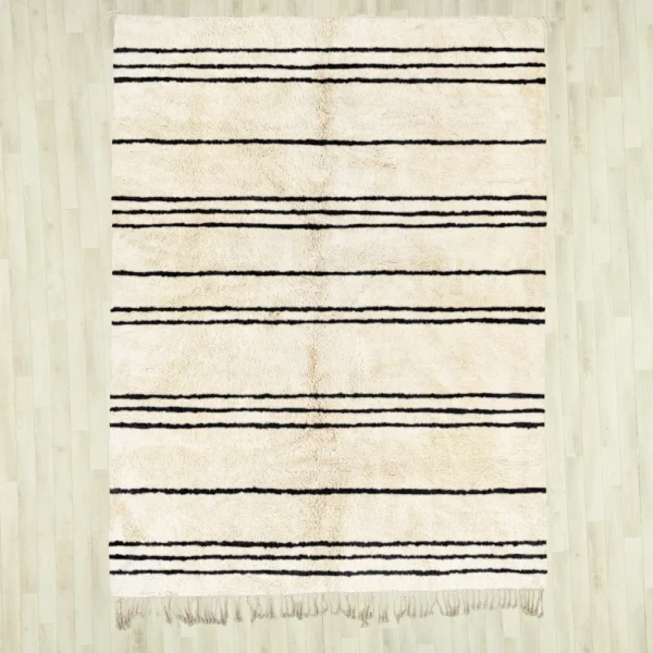 Handmade Beni Ourain rug with classic black and white horizontal stripes, showcasing traditional Moroccan craftsmanship. Perfect for adding a touch of minimalistic elegance and warmth to any living space